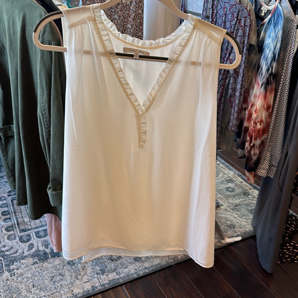 Complete your profession look with this pretty, creamy white blouse!